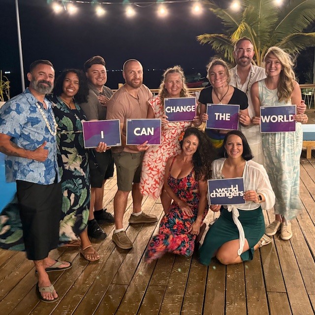Retreat participants holding I Can Change The World banner